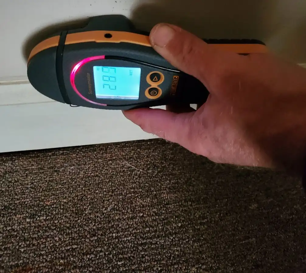 Moisture detection at baseboard during Storm Damage Restoration in Durham
